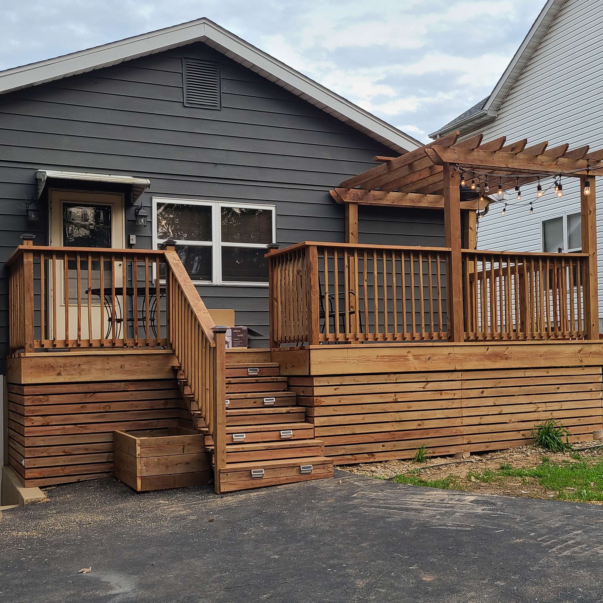 gray house with raised deck