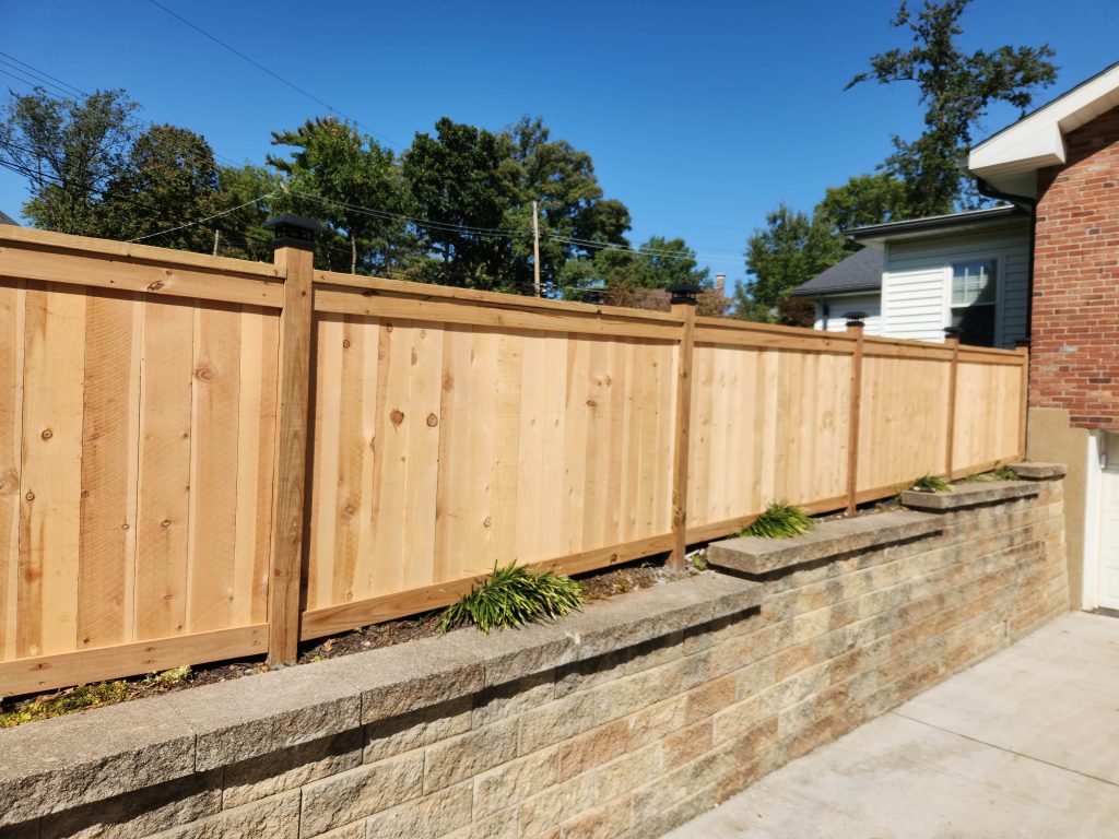 wood fence above retaining wall