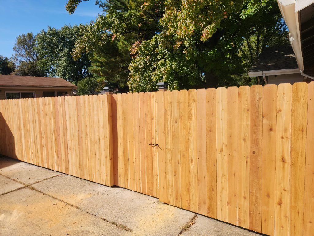 wood fence against sidewalk